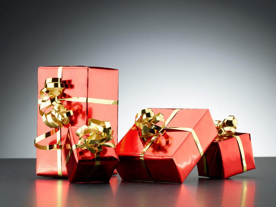 presents wrapped in red paper and gold ribbon